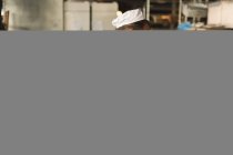 Мужчина-пекарь работает в пекарне — стоковое фото