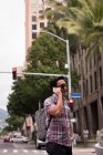 Smart man talking mobile phone in city street — Stock Photo