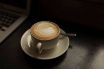 Cup of cappuccino on table in the cafe — Stock Photo