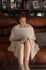 Beautiful woman using laptop at home — Stock Photo