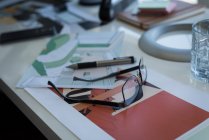 Architectural chart and spectacle on desk at home — Stock Photo