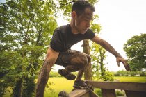Fit man training over obstacle course at boot camp — Stock Photo