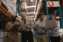 Staffs working together in warehouse — Stock Photo