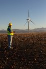 Engineer using mobile phone at wind farm — Stock Photo
