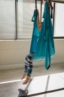 Mulher relaxante em balanço sling rede no estúdio de fitness — Fotografia de Stock