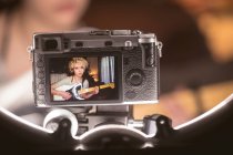 Recording of female blogger playing guitar in camera at home — Stock Photo