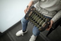 Low section of schoolgirl playing accordion in music school — Stock Photo