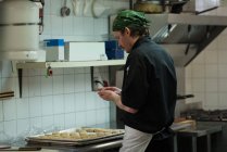 Male chef preparing dough ball in kitchen at restaurant — Stock Photo