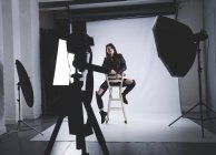 Female model posing for a photo shoot in photo studio — Stock Photo