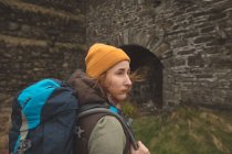 Beautiful female hiker with backpack looking around — Stock Photo