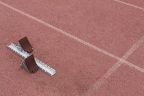 Modern starting blocks on running track — Stock Photo