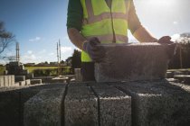 Mid section of engineer holding cement slab at construction site — Stock Photo