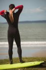 Rear view of surfer with surfboard getting ready for surfing — Stock Photo