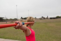 Atleta feminina praticando lançamento de dardo no local de esportes — Fotografia de Stock