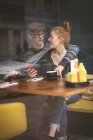 Young couple talking to each other in the cafe — Stock Photo