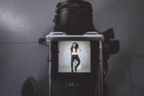Close-up of models picture on digital camera in photo studio — Stock Photo