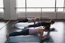 Group of women exercising on exercise mat — Stock Photo