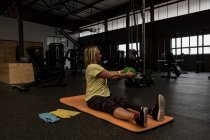 Disabled woman exercising with ball in the gym — Stock Photo