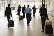 Group of business people walking with suitcase — Stock Photo
