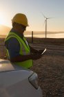 Engineer using a digital tablet at a wind farm — Stock Photo