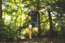 Fit man training over obstacle course at boot camp — Stock Photo