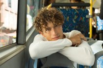 Portrait of young man travelling in the bus — Stock Photo