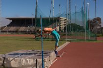Female athlete practicing high jump at sports venue — Stock Photo