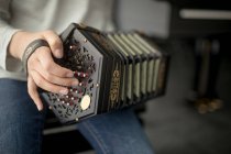 Mid section of schoolgirl playing accordion in music school — Stock Photo