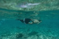 Donna che fa snorkeling sott'acqua in mare turchese — Foto stock