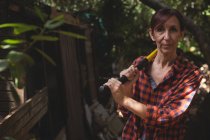 Portrait of confident woman standing with axe — Stock Photo