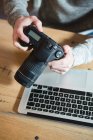 Mid section of man using digital camera at home — Stock Photo