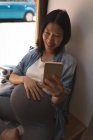 Pregnant woman talking selfie with mobile phone at cafe — Stock Photo