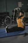 Handicapped man exercising with barbell in gym — Stock Photo