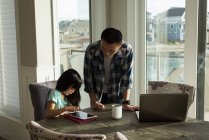Отец и дочь используют цифровой планшет дома — стоковое фото