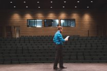 Male actor reading script on stage at theatre. — Stock Photo