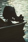 Silhouette of motorboat in a lake — Stock Photo