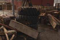 Wooden plank and tyre at scrapyard near shipyard — Stock Photo
