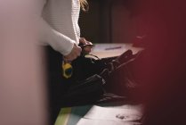 Mid section of tailor checking clothes at tailor shop — Stock Photo