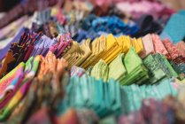 Various color fabric arranged in row in tailor shop — Stock Photo