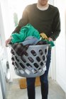 Man holding basket of laundry clothes at home — Stock Photo