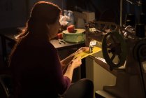 Кравець швейної тканини з швейною машиною в крамниці кравець — стокове фото