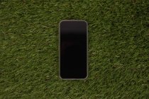 Mobile phone of artificial grass — Stock Photo