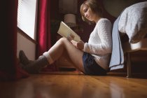 Schöne Frau liest Buch im Schlafzimmer zu Hause — Stockfoto