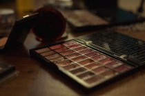 Close-up of eye shadow pallete at table indoors — Stock Photo