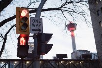 Traffic signal with signboard at dusk — Stock Photo