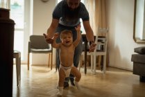 Father playing with son at home — Stock Photo