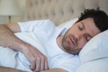 Man sleeping in bedroom at home — Stock Photo