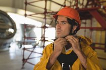 Young male worker wearing hard hat at solar station — Stock Photo