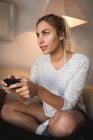 Woman playing video game in living room at home — Stock Photo