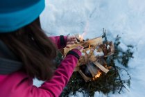 Close-up of woman warming up by bonfire during winter. — Stock Photo